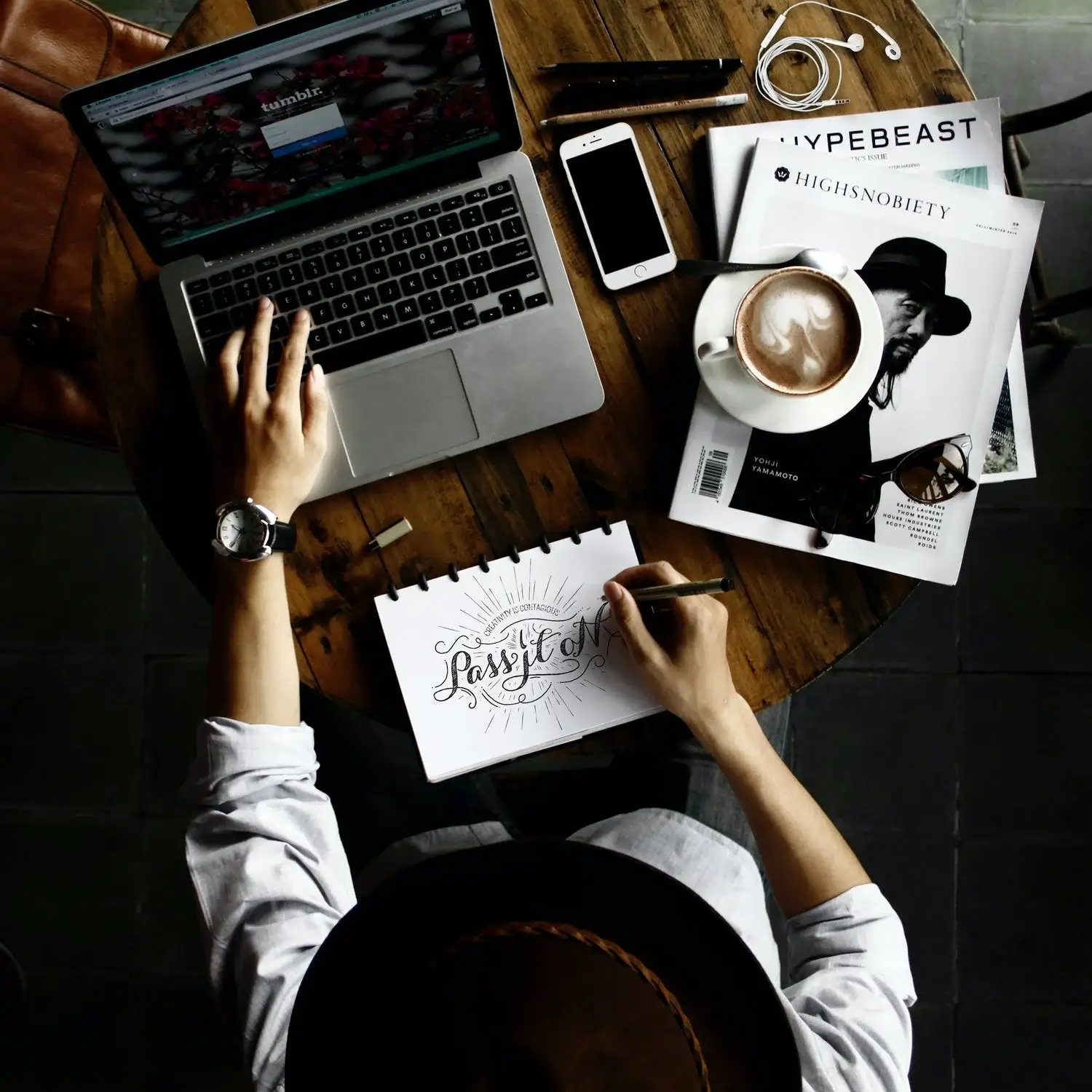 Laptop, smartphone, and design magazine showcasing creative lifestyle and submissions for 10Musica.
